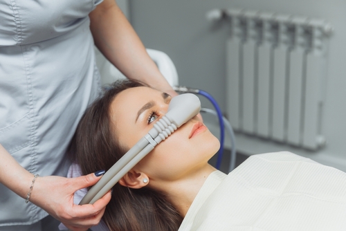 woman receiving laughing gas at dental office