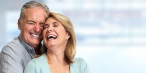 older couple smiling and hugging 
