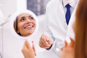 woman admiring smile in the mirror