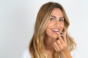 woman putting in invisalign