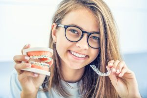 young lady with braces and invisalign