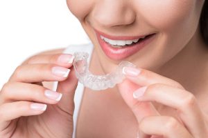 woman putting in clear aligners