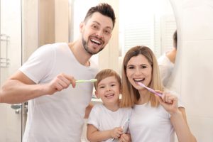 family brushing their teeth
